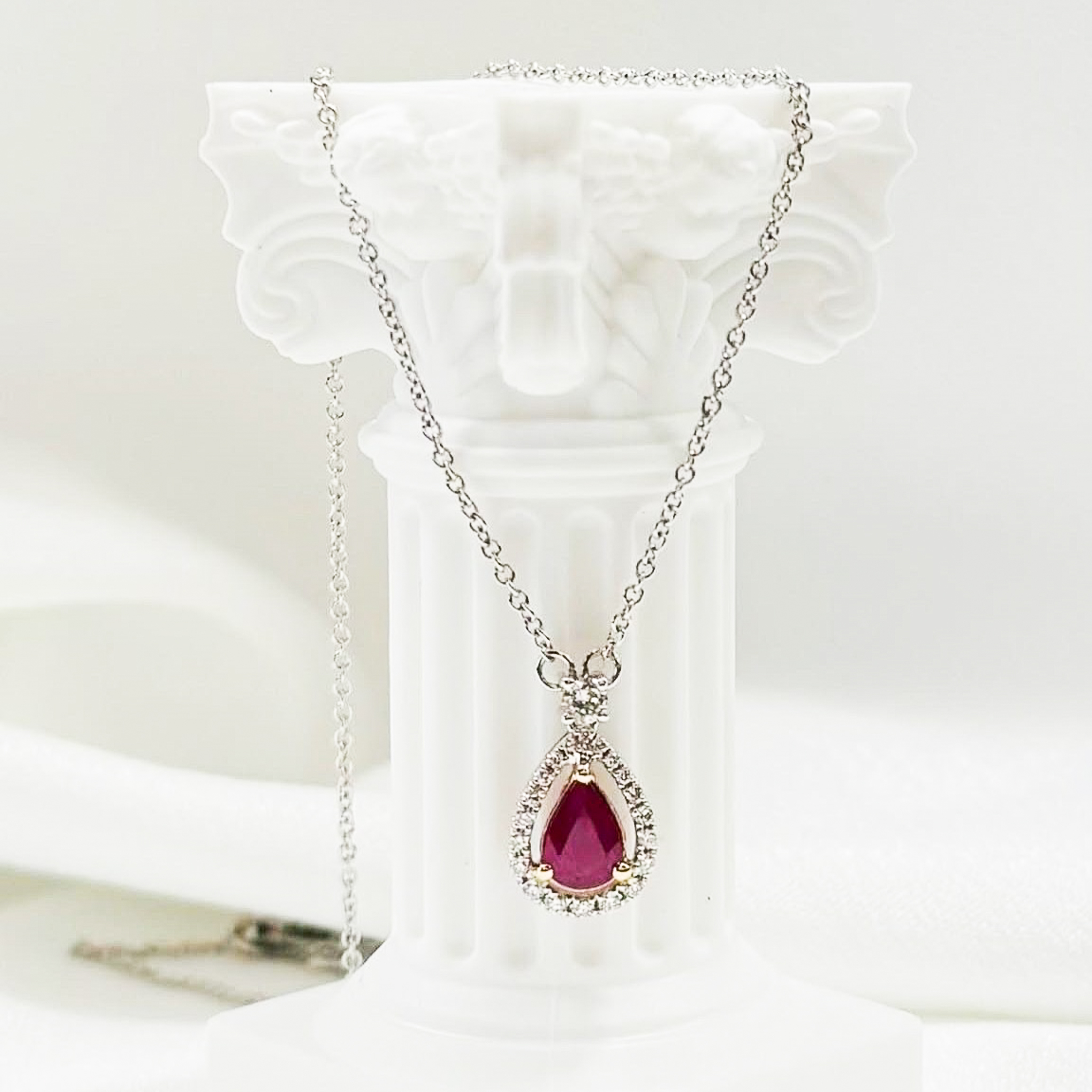 Stunning ruby teardrop pendant necklace with diamond halo setting